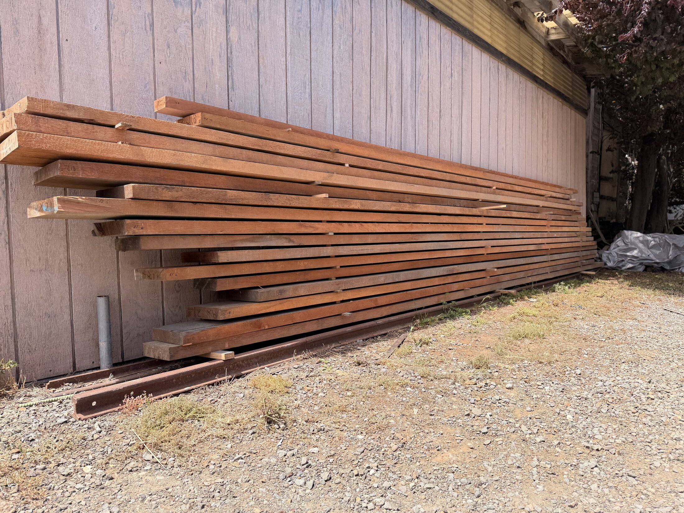 Douglas fir planking stock stacked and stickered at Richardson Bay Boatworks